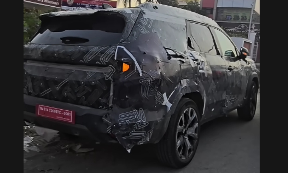 Renault Bigster 7 seater SUV rear-side view spied testing in India with camouflage.